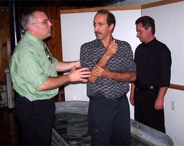 Rusty preparing to baptize a gentleman in the Name of Jesus Christ